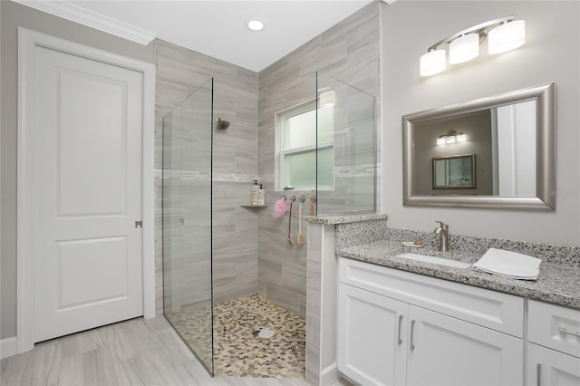 bathroom featuring vanity and a shower with shower door