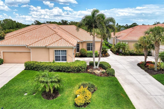 mediterranean / spanish-style house with a garage, stucco siding, concrete driveway, and a front yard