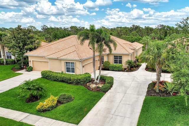 mediterranean / spanish home featuring a front lawn and a garage