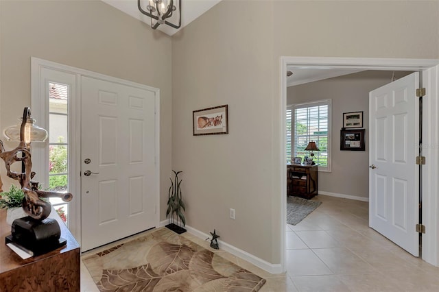 foyer featuring a chandelier and light tile patterned floors