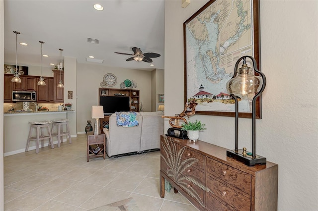 living room with light tile patterned floors and ceiling fan