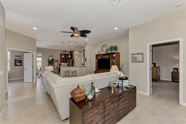 living room with ceiling fan and light tile patterned floors