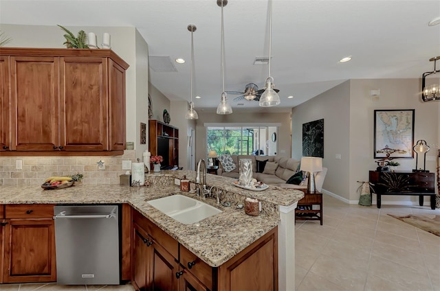 kitchen featuring kitchen peninsula, sink, pendant lighting, light tile patterned floors, and tasteful backsplash