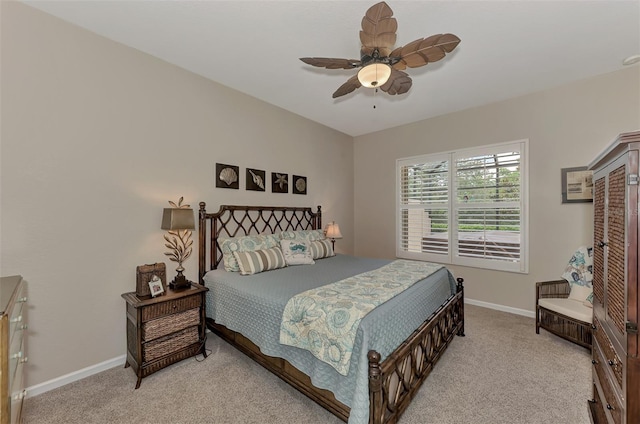 bedroom with baseboards, light carpet, and a ceiling fan