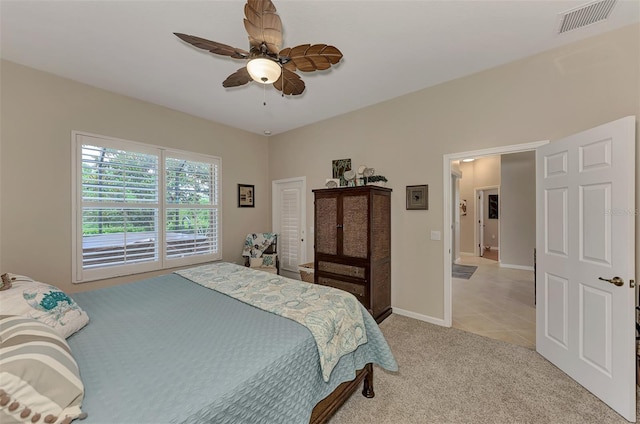 bedroom featuring visible vents, a ceiling fan, baseboards, and light carpet