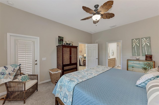 bedroom featuring a ceiling fan, visible vents, baseboards, light carpet, and ensuite bath