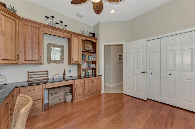 office with built in desk, light wood-type flooring, and ceiling fan