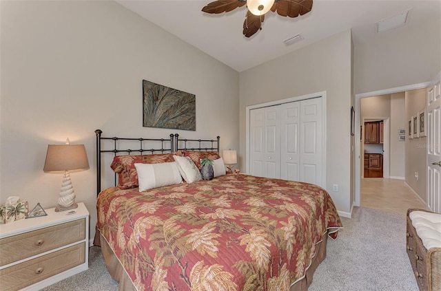 bedroom featuring ceiling fan, visible vents, light carpet, and a closet