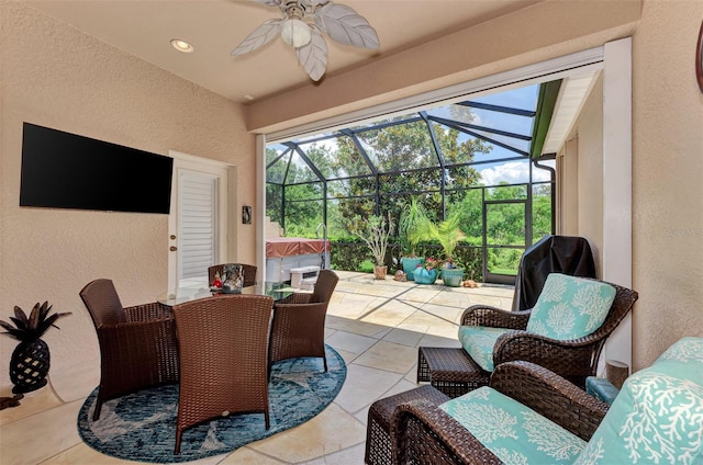 view of patio featuring a hot tub, ceiling fan, a lanai, and outdoor dining space