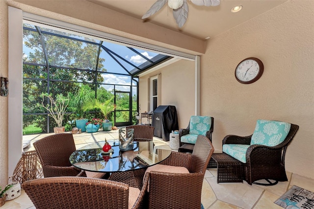 sunroom / solarium featuring plenty of natural light, outdoor dining space, and ceiling fan
