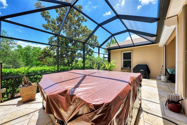 view of patio featuring a jacuzzi and a lanai