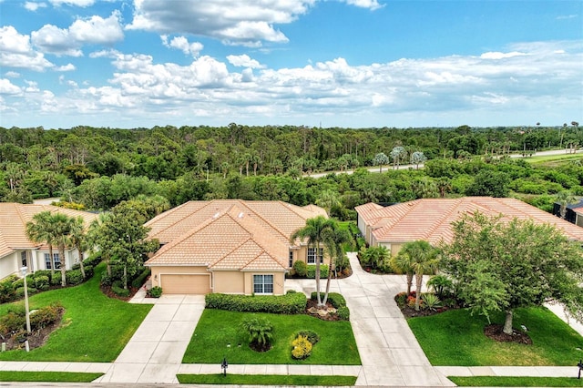 bird's eye view with a wooded view