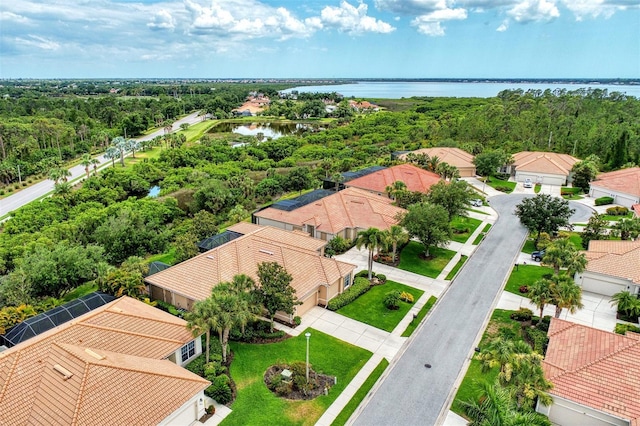 drone / aerial view with a residential view and a water view