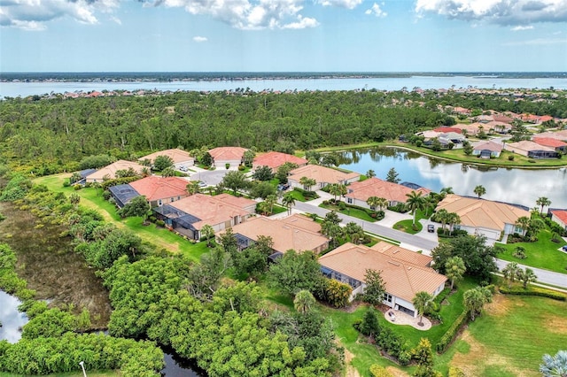 drone / aerial view featuring a water view and a residential view