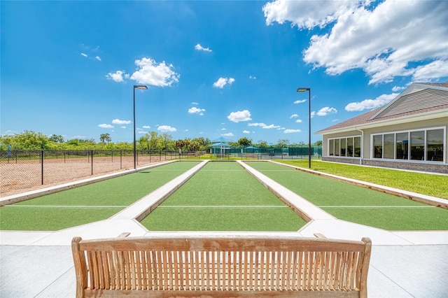 view of community featuring fence