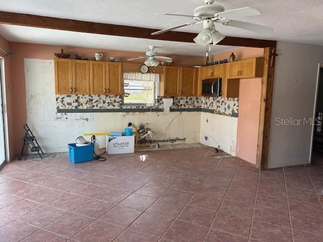 kitchen featuring tile patterned flooring, ceiling fan, and beamed ceiling