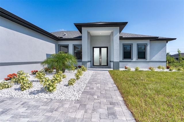 12004 Newgate Ave, Port Charlotte, FL 33981 - entrance to property featuring a yard, stucco siding, and roof with shingles