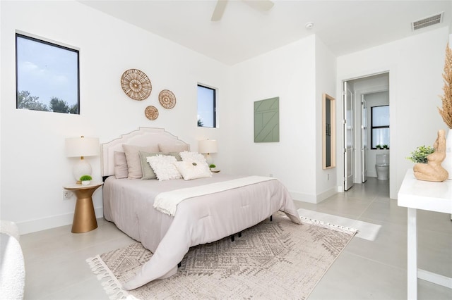 tiled bedroom with ensuite bathroom and ceiling fan