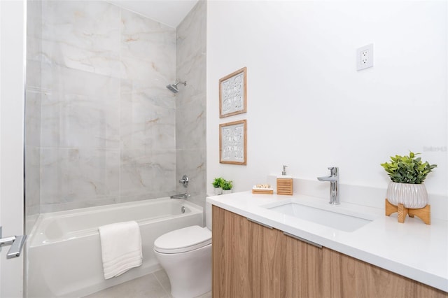 full bathroom featuring toilet, tiled shower / bath, vanity, and tile patterned flooring