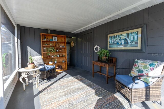 interior space featuring concrete floors and wood walls