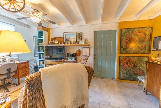 interior space featuring ceiling fan and beamed ceiling