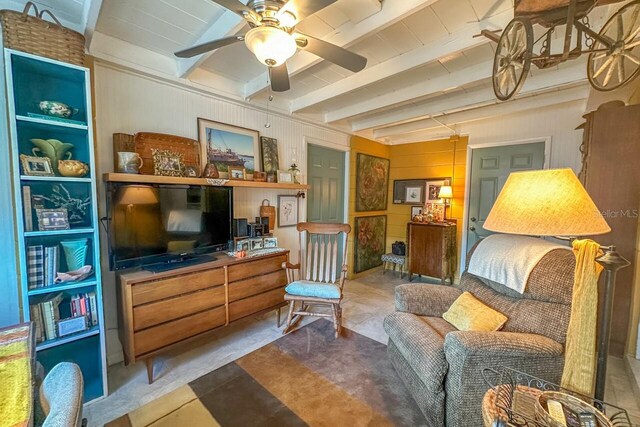 sitting room with beam ceiling and ceiling fan