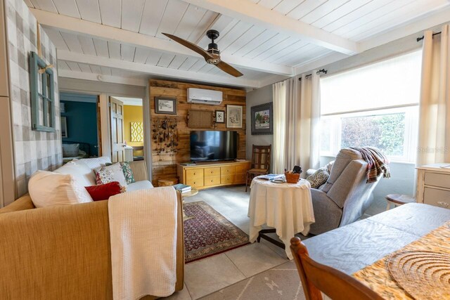 tiled living room featuring ceiling fan, beamed ceiling, wood ceiling, and a wall unit AC