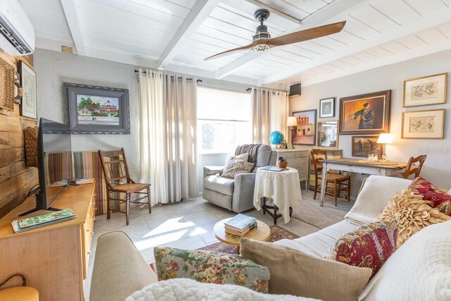 sitting room with ceiling fan, beamed ceiling, wooden ceiling, a wall unit AC, and light tile patterned floors