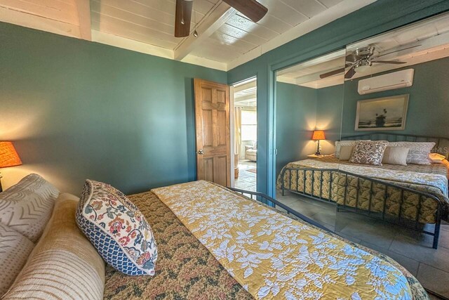 tiled bedroom featuring beam ceiling, an AC wall unit, and ceiling fan