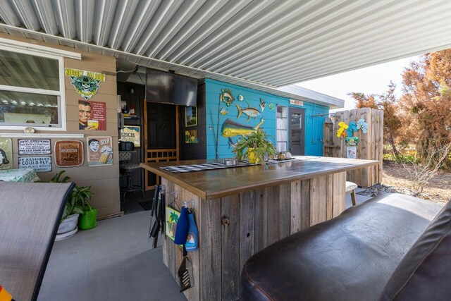 exterior space featuring a wealth of natural light, stainless steel gas stovetop, and concrete floors