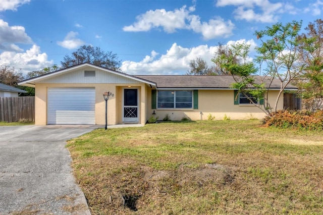 single story home featuring a garage and a front lawn