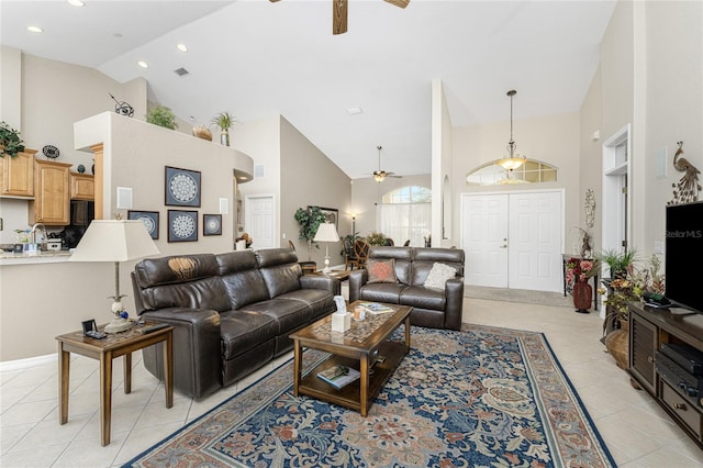 tiled living room featuring high vaulted ceiling and ceiling fan