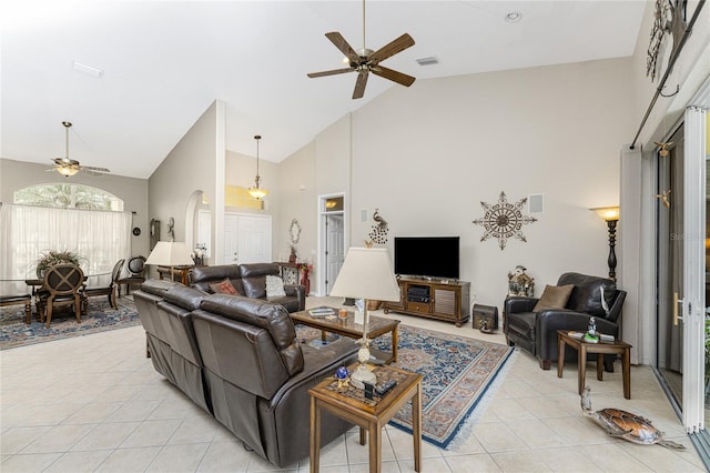 living room featuring light tile patterned floors, high vaulted ceiling, and ceiling fan