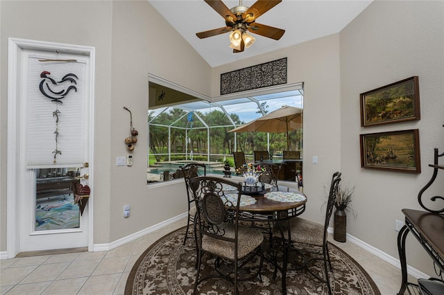 tiled dining space featuring lofted ceiling and ceiling fan