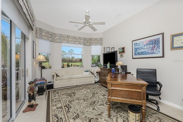 tiled office space featuring ceiling fan and plenty of natural light