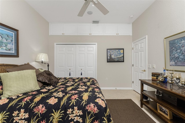 bedroom featuring light tile patterned flooring, a closet, and ceiling fan