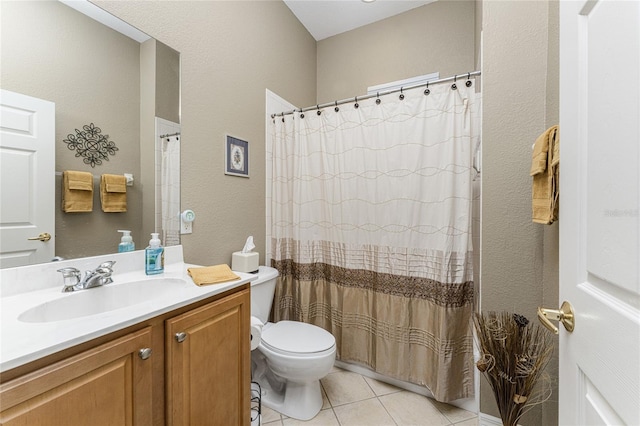 bathroom featuring walk in shower, vanity, toilet, and tile patterned floors