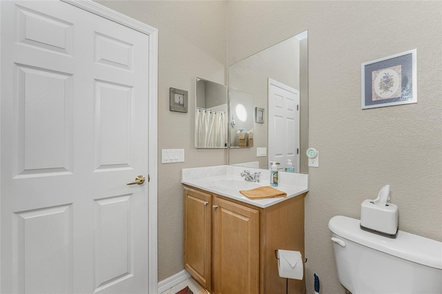 bathroom featuring toilet and vanity