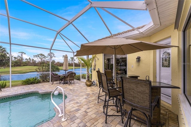 view of swimming pool featuring a patio area, a lanai, and a water view