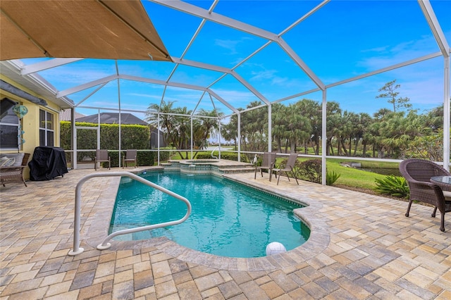 view of pool with a patio area and glass enclosure