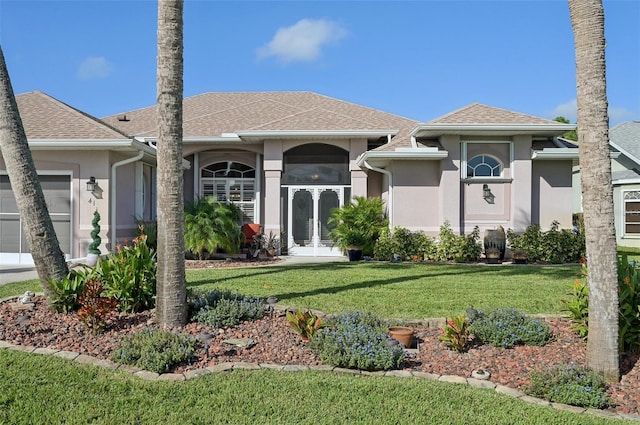 view of front facade with a garage and a front yard