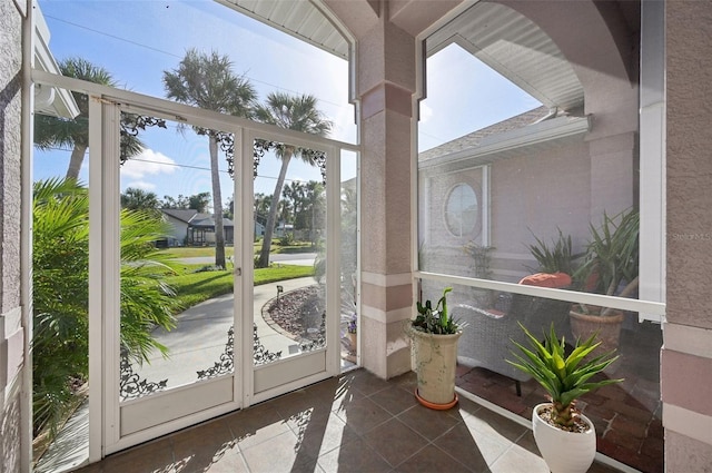 doorway to outside with tile patterned floors