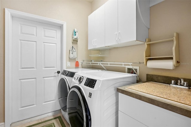 laundry area with cabinets, washer and dryer, and hardwood / wood-style flooring