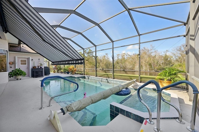 view of swimming pool featuring a patio area and glass enclosure