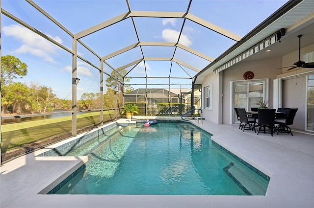 view of pool with glass enclosure, ceiling fan, and a patio area