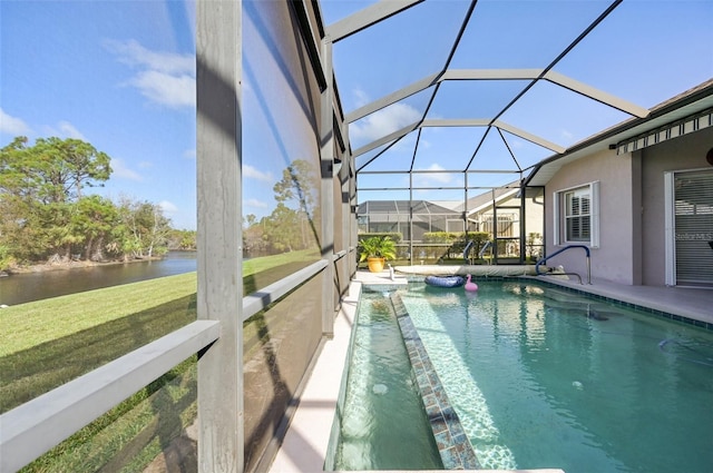 view of swimming pool featuring a lawn, glass enclosure, and a water view