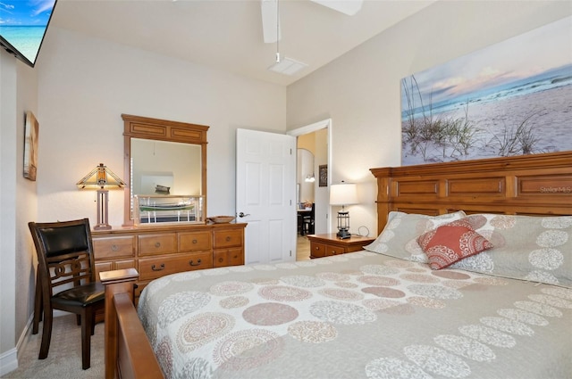 carpeted bedroom with vaulted ceiling and ceiling fan