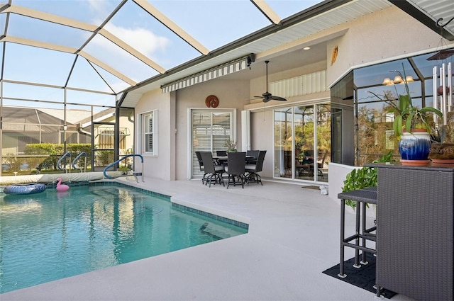 view of swimming pool with ceiling fan and a patio