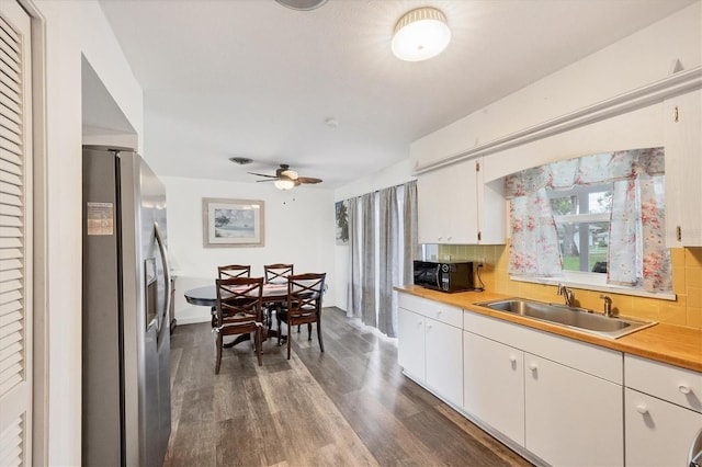 kitchen with sink, white cabinets, stainless steel refrigerator with ice dispenser, and backsplash