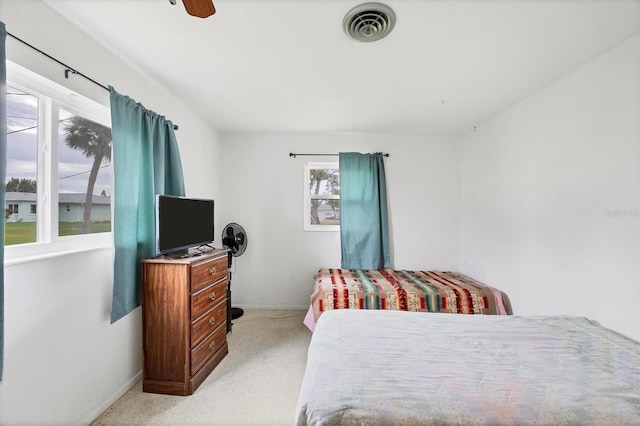 bedroom with light carpet and ceiling fan